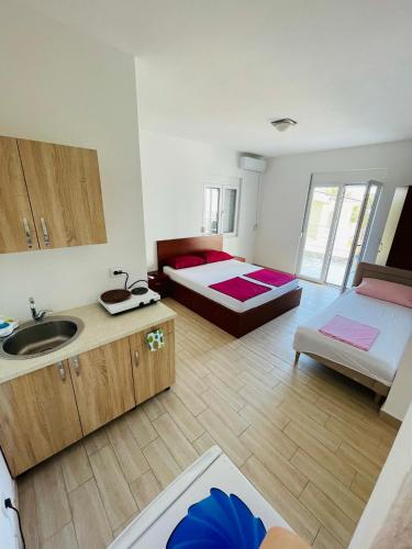 a room with two beds and a sink at Apart Hotel White Pearl in Bar