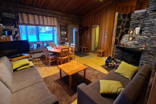 a living room with a couch and a table at Holiday Pyhäniemenranta in Kihniö