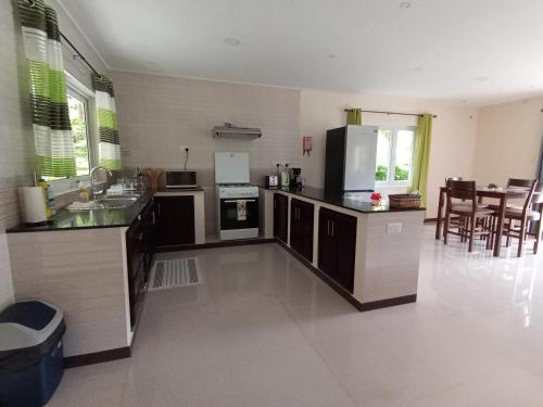 a kitchen with a refrigerator and a counter top at Jaidss Holiday Apartments 2 in Victoria