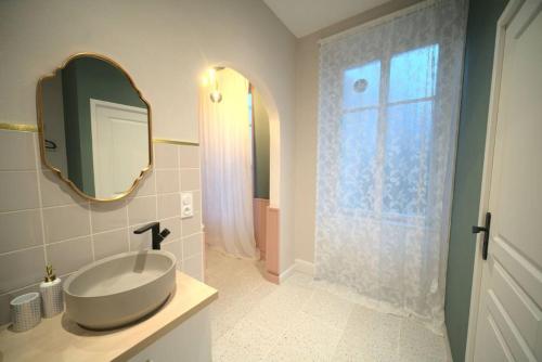 une salle de bain avec un lavabo et un miroir dans l'établissement Royal Room jacuzzi haut de gamme centre ville, à Mulhouse