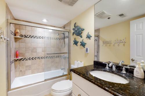 a bathroom with a sink and a shower and a toilet at Sea Colony -- 112 Georgetowne in Bethany Beach
