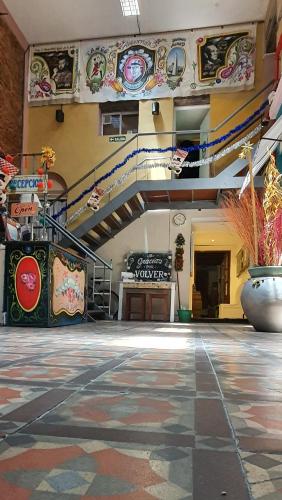 a large room with a staircase in a building at BA Stop Hotel House in Buenos Aires