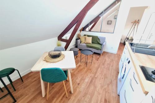 un salon avec une table, des chaises et un canapé dans l'établissement L'amiral n4 T2 dernier étage ByLocly, à Lorient