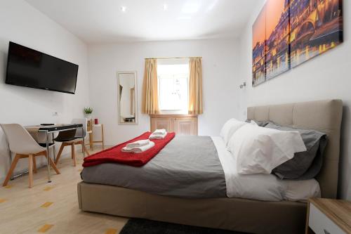 a bedroom with a bed and a desk and a television at La Casa degli Osti 2 - Piazza Navona in Rome