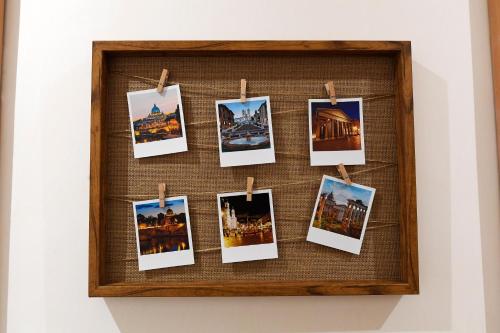 a frame of pictures hanging on a wall at La Casa degli Osti 2 - Piazza Navona in Rome