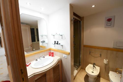 a bathroom with a sink and a toilet and a mirror at La Casa degli Osti 2 - Piazza Navona in Rome