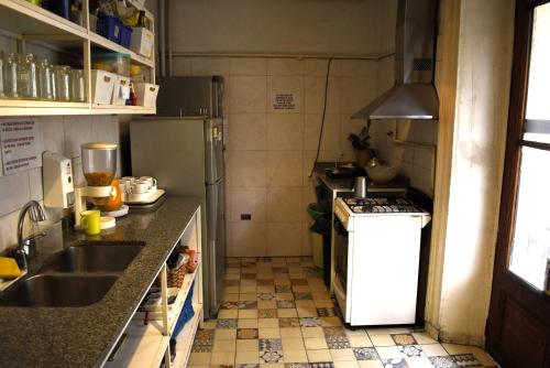 a small kitchen with a sink and a refrigerator at BA Stop Hotel House in Buenos Aires