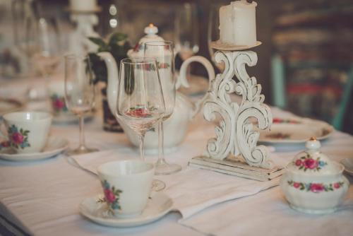 a table with cups and glasses on a table at Ribarska kuća - Ilok ,tradicijska kuća-sobe in Ilok