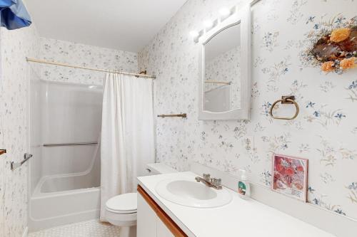 a bathroom with a sink and a toilet and a shower at Bethany Pines -- 412 Bethany Drive in Bethany Beach