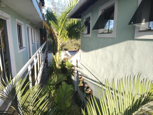 an external view of a house with plants next to it at Airport Pousada in Cabo Frio