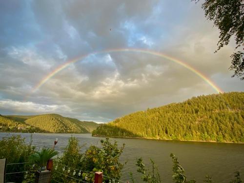 a rainbow in the sky over a body of water at Glückshütte in Unterwellenborn