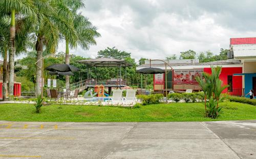 a park with a playground with a slide at Hotel Los Rios in Guácimo