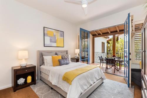 a bedroom with a bed and a balcony with a table at Legacy Villa Resort- 48613 Classic Drive in La Quinta