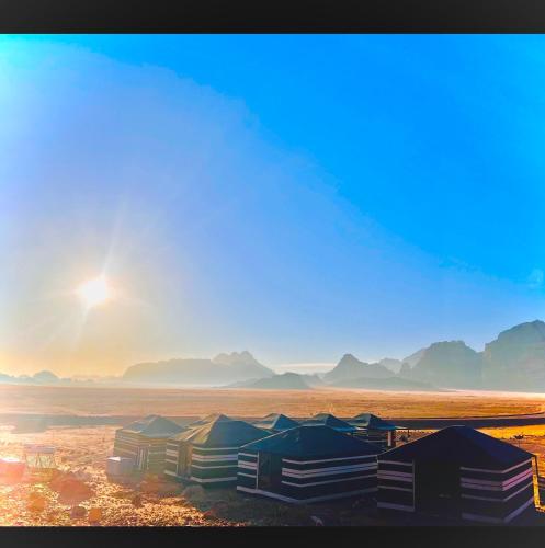 a painting of a desert with mountains in the background at Shakria Bedouin Life Camp in Wadi Rum
