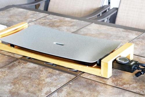 a laptop on a stand on a table at Beach Side Secret in Ginoza