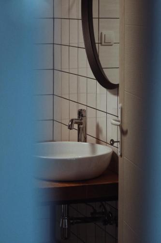 a bathroom with a white sink and a mirror at Kačara Vodeničko brdo in Pranjani