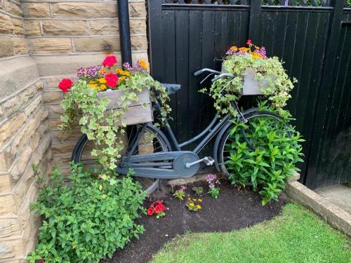a bike with flower boxes on the side of a fence at Shelbourne House in Harrogate