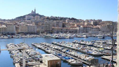 a harbor filled with lots of boats on a cloudy day at Hotel Belle-Vue Vieux-Port in Marseille