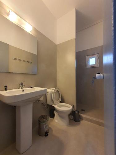 a bathroom with a sink and a toilet at Teoria Paros - Matsas Windmill in Naousa