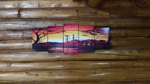 a painting hanging on a wall at Cabaña LA EMILIA Uspallata Mdz in Uspallata