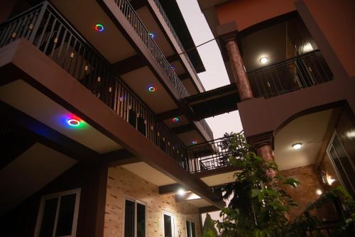 a building with two balconies with lights on it at Homey Lodge in Kumasi