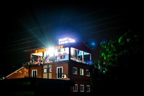 a building with lights on top of it at night at Homey Lodge in Kumasi