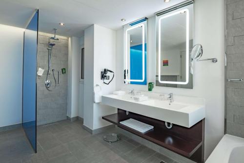 a bathroom with a sink and a shower at Park Inn by Radisson Najran in Najran