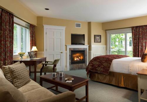 a hotel room with a bed and a fireplace at Lord Camden Inn in Camden