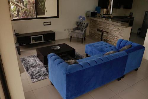 a living room with a blue couch and a fireplace at The Heights in Montañita in Montañita