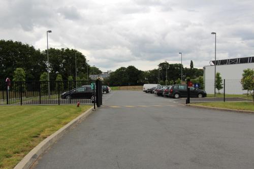 a parking lot with cars parked in a parking lot at Hôtel ibis Guingamp Cœur de Bretagne in Ploumagoar