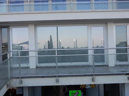 a balcony of a building with a view of a city at Gelijkvloers zeezicht appartement Sterckx in Blankenberge