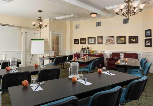 a dining room with tables and chairs and a podium at Lord Camden Inn in Camden