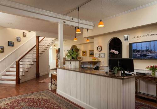 a lobby with a counter and a staircase at Lord Camden Inn in Camden