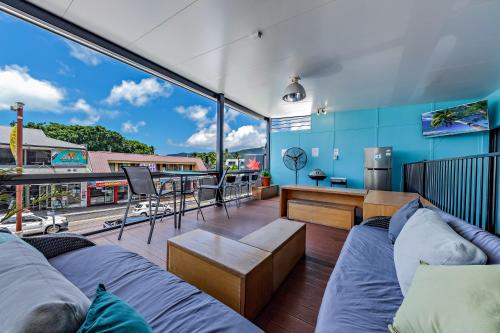 a living room with a couch and a table at Airlie Sun & Sand Accommodation Studio #1 in Airlie Beach