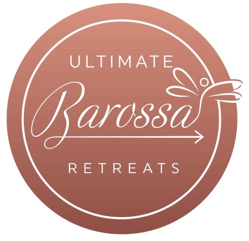 a brown circle with the words ultimate zazalesça retreats written at Ultimate Barossa Retreats in Tanunda