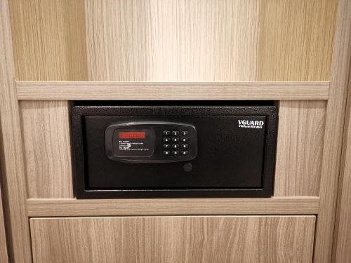 Un horno microondas en una puerta de madera en una habitación. en VENO HOTEL, en George Town