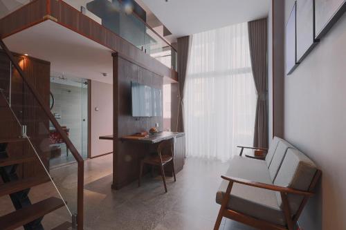 a room with a staircase and a desk and a chair at CHERRY BOUTIQUE HOTEL in Ho Chi Minh City