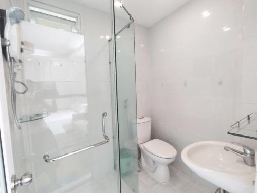 a bathroom with a shower and a toilet and a sink at Saigon Apartments 2 in Ho Chi Minh City