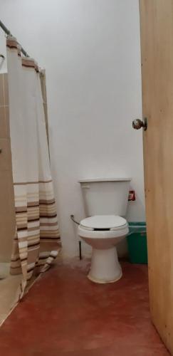 a bathroom with a white toilet in a room at Centro Ecoturistico Ya´ajche in Lacanjá