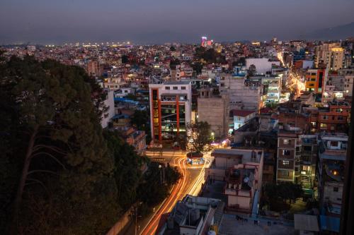 a city lit up at night with cars at Basera Boutique Hotel in Kathmandu