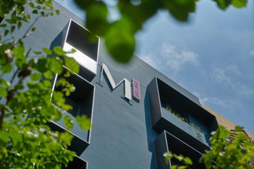 a building with a sign on the side of it at M Village Living Võ Thị Sáu in Ho Chi Minh City