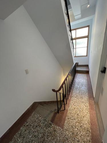 a stairway with a bench and a window at Rolling Pin Homestay in Tainan