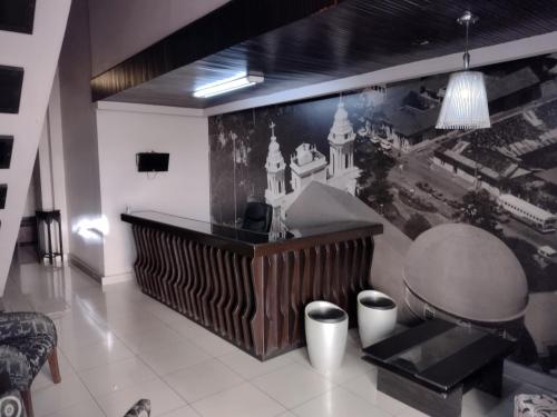 a lobby with a large painting on the wall at Hotel Alajuela Costa Rica Airport in Alajuela City