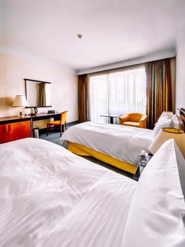 Ένα ή περισσότερα κρεβάτια σε δωμάτιο στο Rahat Palace Hotel