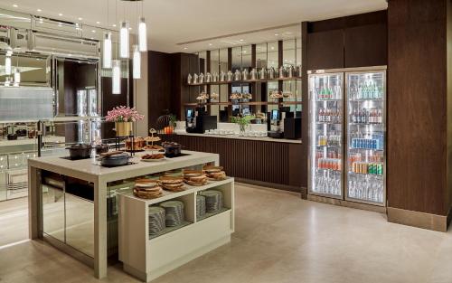 a kitchen with a counter with food and drinks at Montien Hotel Surawong Bangkok in Bangkok