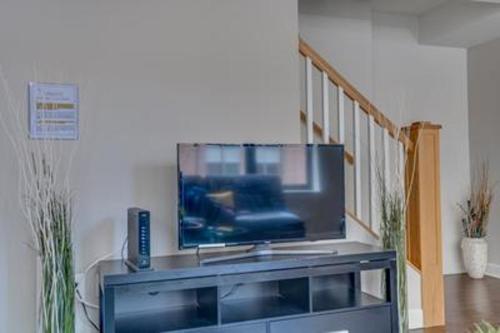 a flat screen tv sitting on top of a entertainment center at Waterfront Baltimore 2BR Furnished Apartment apts in Baltimore