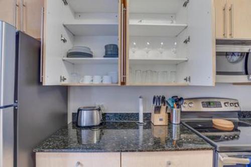 a kitchen with white cabinets and a counter top at Waterfront Baltimore 2BR Furnished Apartment apts in Baltimore