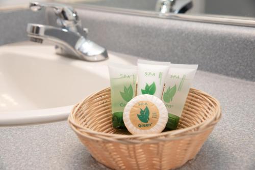 a basket of toothbrushes and toiletries in a bathroom at Traveler's inn in Carlin