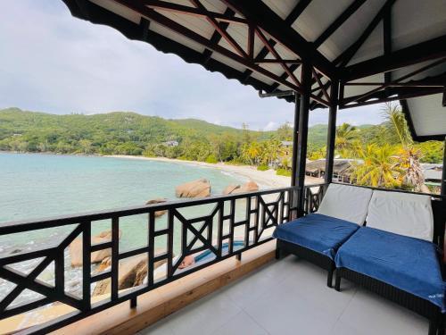 a balcony with a view of the beach at Villa Chez Batista in Takamaka