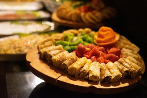 a plate of fruit and vegetables on a table at Lunar Cappadocia Hotel in Goreme